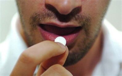 the man takes a pill for stimulation